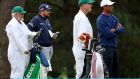 Augusta, Georgia: Shane Lowry of Ireland, his caddie Brian Martin, Tiger Woods and his caddie Joe LaCava prepares to play shots on the 15th hole the Masters last weekend. 