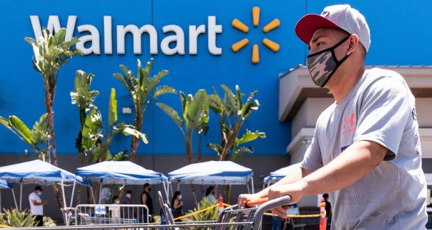 A Walmart shopper wears a mask as protection against the coronavirus as he exits a Walmart Supercenter in Burbank, California. Photograph: Etienne Laurent/EPA
