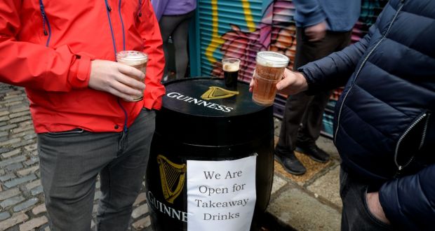 People enjoy takeaway pints in Dublin’s Temple Bar. Photograph: Alan Betson / The Irish Times