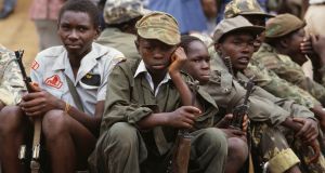 Child soldiers watch the inauguration of Yoweri Museveni in 1986. Photograph: William Campbell/Sygma via Getty