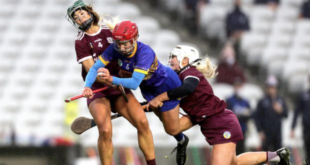 Tipperary’s Karen Kennedy collides with Heather Cooney and Shauna Healy of Galway during the Liberty Insurance All-Ireland senior camogie semi-final at Páirc Uí Chaoimh. Photograph: Laszlo Geczo/Inpho