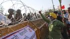 An elderly farmer argues with policemen standing by a barricade as they attempt to move towards Delhi, at the border between Delhi and Haryana state last Friday. Photograph: Altaf Qadri/AP
