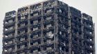 The charred remains of clading are pictured on the outer walls of the burnt-out shell of the Grenfell Tower block in north Kensington. Photograph: Niklas  Halle’n/ AFP/Getty 
