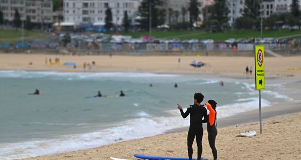 Surfers at Bondi Beach in Sydney on Sunday. Photograph: Steven Saphore/AFP via Getty Images