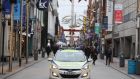 A Garda car on Henry Street in Dublin city centre, where retailers have been asked to defer sales until January.  Photograph: Brian Lawless/PA Wire