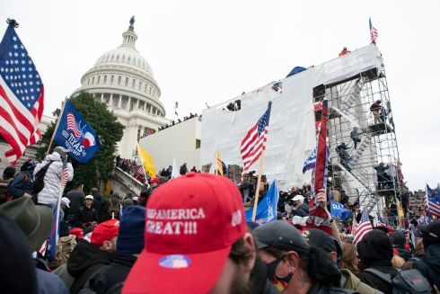 Supporters of US president Donald Trump climb on an inauguration platform on the West Front of the US Capitol during a riot on Wednesday. Photograph: Jose Luis Magana/AP
