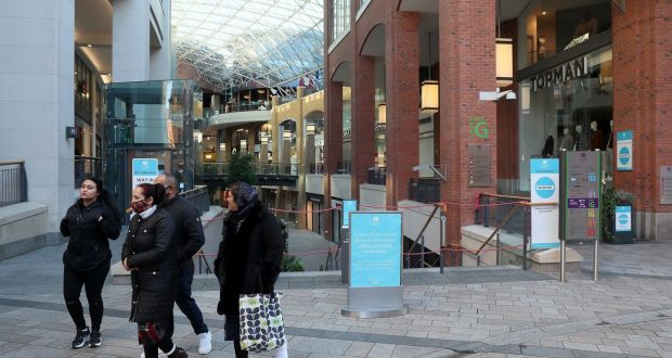 People walk past the closed Victoria Square Shopping centre in Belfast city centre as the  Covid-19 lockdown in Northern Ireland continues. Photograph: Brian Lawless/PA Wire