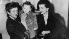  Jane Russell (right) with  Irish-born infant  Thomas Kavanagh at New York airport. The boy was taken to Russell by his mother, who pleaded with the Hollywood star  to take him to the US. Photograph: Keystone/Getty Images.