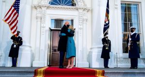 President Joe Biden and first lady Jill Biden embrace in front of the White House in Washington during inauguration day. Photograph: Doug Mills/The New York Times