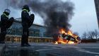 Police watch a car that has been set on fire on 18 Septemberplein in Eindhoven, the Netherlands, on Sunday. Photograph: Photograph: Rob Engelaar/EPA