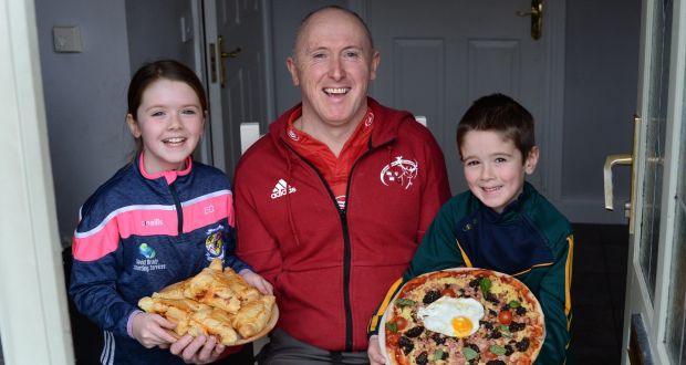 Phil Quinlan, with his children Joe and Eileen, with some food they prepared at home in Navan, Co. Meath. Photograph: Dara MacDónaill/The Irish Times