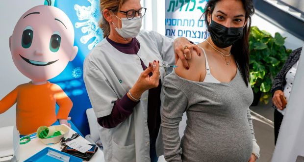 A health worker administers a dose of the Pfizer/BioNTech coronavirus vaccine to a pregnant woman at Clalit Health Services, in Tel Aviv, Israel  in January. Photograph: Jack Guez/AFP via Getty Images