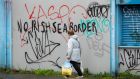 Graffiti on a building reads “No Irish Sea border” in the Sandy Row area in Belfast. Photographer: Paul Faith/Bloomberg