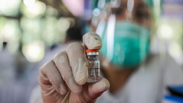 A healthcare worker shows a dose of Sinovac Covid-19 vaccine during a mass vaccination drive for healthcare workers in Medan, North Sumatra, Indonesia. Photograph: EPA