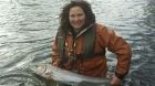 Glenda Powell of Blackwater Lodge Fishery releasing a salmon from the River Blackwater.