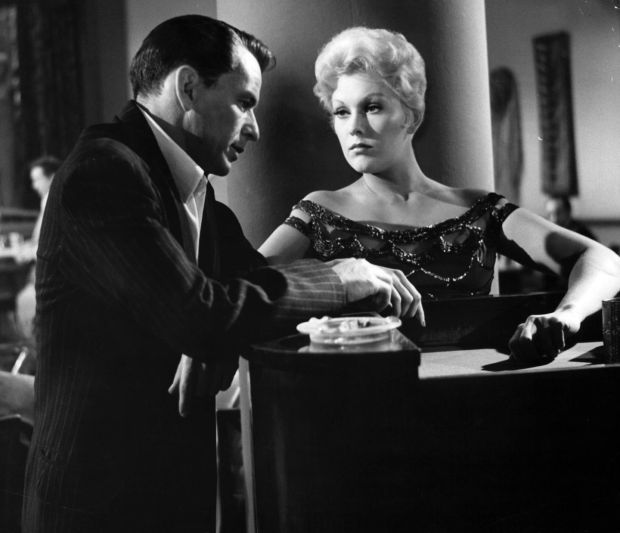 A dour Frank Sinatra is listened to by Kim Novak in a scene from the film ‘The Man With The Golden Arm’, 1955. Photograph: United Artists/Getty Images