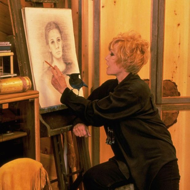 Retired actress Kim Novak sketching portrait of unidentified girl as pet blue jay stands on her arm at her Oregon ranch house. Photograph: by Charles W Bush/The LIFE Images Collection via Getty Images/Getty Images