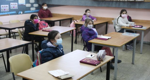 Children wear face masks in class in a Junior School in Jerusalem. Israel reopened schools, almost two months after they were closed due to the coronavirus pandemic. Photograph: Abir Sultan/EPA