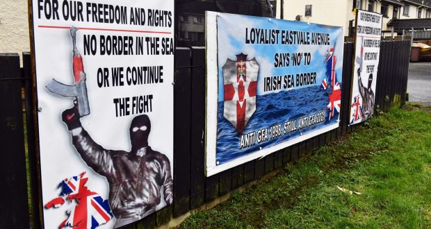 Placards depict a gunman in a Protestant estate in Co Tyrone: the protocol is  an attempt to avoid the worst consequences of Brexit for the island of Ireland, both North and South.