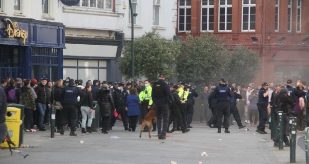 Gardaí and protesters outside St Stephen’s Green in Dublin on Saturday. Photograph: Ronan McGreevy