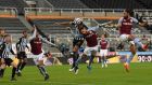 Jamaal Lascelles jumps to score Newcastle’s equaliser against Aston Villa. Photograph: Stu Forster/Getty/AFP