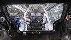 Volkswagen employees work on the assembly of an electric car at its plant in Zwickau, eastern Germany. Photograph: Henrik Schmidt/AFP