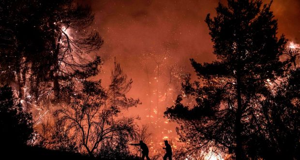 Extreme weather: firefighters try to extinguish a wildfire on the island of Evia, northeast of Athens, in 2019. Photograph: Angelos Tzortzinis/AFP