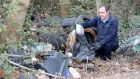 Community warden Alan Nolan examining illegal dumping near Clonee in Co Meath. Photograph: Alan Betson