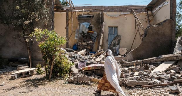 A woman walks in front of a damaged house which was shelled as federal-aligned forces entered the city, in Wukro, north of Mekele, on March 1st. Photograph: Eduardo Soteras/AFP