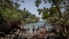  Tourists board a boat on the coast of the Banana Islands. Photograph:  Sally Hayden