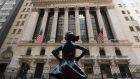 The New York Stock Exchange   at Wall Street and the ‘Fearless Girl’ statue   in New York City. Photograph: Angela Weiss/AFP via Getty Images