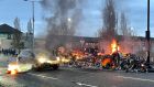 The wreckage of a bus on fire on the Shankill Road in Belfast. Photograph: Liam McBurney/PA Wire.