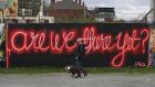 ‘Are We There Yet?’ street art in the Grand Canal Basin area of Dublin: a phased reopening of the economy is expected to begin in May, but no dates have been set. Photograph: Nick Bradshaw for The Irish Times