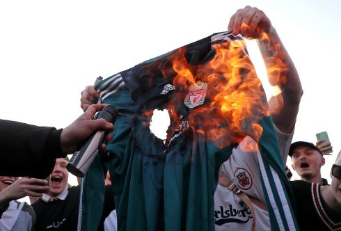 Fans burn a Liverpool jersey before the club's Premier League match against Leeds on Monday. Photograph: PA
