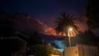 Residential neighbourhoods are lit by raging fires in Cape Town, South Africa. Photograph: Jerome Delay/AP Photo