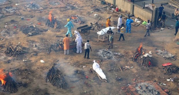 Multiple funeral pyres of  patients who died of Covid-19  are seen burning at a ground that has been converted into a crematorium for mass cremation of coronavirus victims, in New Delhi. Photograph: AP Photo