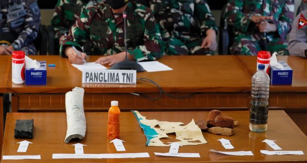 A military officer displays debris believed to be from a missing Indonesian Navy submarine KRI Nanggala during a press conference at a command in Ngurah Rai Airport in Bali. Photograph: Made Nagi/EPA 