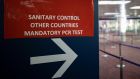 A sign in Charles de Gaulle airport near Paris indicates the way to a sanitary control point for passengers arriving from countries listed as red zones. Photograph: Ian Langsdon/EPA