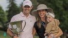 Rory McIlroy poses with the  trophy alongside  his wife Erica and daughter Poppy after winning the Wells Fargo Championship at Quail Hollow Club in Charlotte, North Carolina. Photograph: Tannen Maury/EPA
