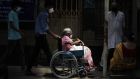  Relatives push an elderly woman in a wheelchair as she arrives for a Covid-19 vaccination at a government hospital in Kolkata, India. Photograph: Piyal Adhikary/EPA