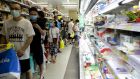People wait in line at a busy supermarket in Taipei, Taiwan, on Saturday. Photograph: I-Hwa Cheng/Bloomberg