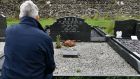 Former hunger striker Laurence McKeown at the grave of Dr David Ross, at Kirkinriola Cemetery. Photograph: Colm Lenaghan/Pacemaker