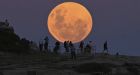 People watch as the ‘super flower blood moon’ rises over Bondi Beach in Sydney on May 26th, 2021. Photograph: Steven Saphore/Anadolu Agency via Getty