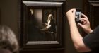 A museum guest photographs Johannes Vermeer’s Woman Holding a Balance in the National Gallery of Art in Washington. Photograph: TJ Kirkpatrick/The New York Times