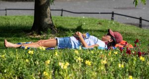 A woman enjoys the sun in St Stephens Green in Dublin. Photograph: Damien Eagers/PA Wire 