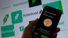 Robinhood receives an average of 2.5 cents for every $100 traded; the more clients trade, the more money it makes. Photograph:   Chris Delmas/AFP via Getty Images