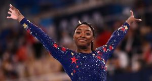  Simone Biles reacts after competing in the artistic gymnastics balance beam event of the women’s qualification during the Tokyo   Games. Photograph: Loic Venance/AFP via Getty Images