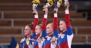 Russian athletes celebrate winning the gold medal during the podium ceremony of the artistic gymnastics women’s team final  the Ariake Gymnastics Centre in Tokyo. Photograph: Lionel Bonaventure/AFP/Getty Images
