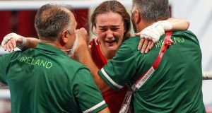 Ireland’s Kellie Harrington celebrates after winning the lightweight Olympic gold medal with coaches Zaur Antia and John Conlan. Photo: James Crombie/Inpho