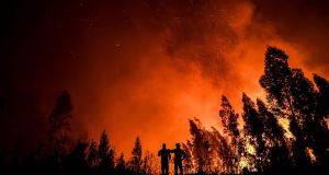 Firefighters monitor the progression of a wildfire at Amendoa in Macao, central Portugal in July 2019. Photograph: AFP via Getty Images